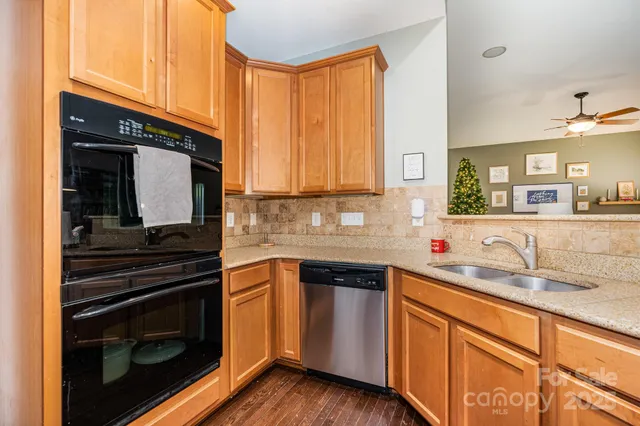 a kitchen with stainless steel appliances a stove sink and cabinets