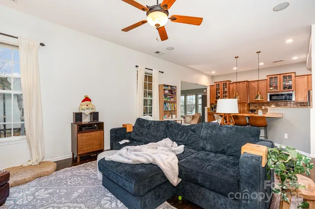 a living room with furniture and a chandelier