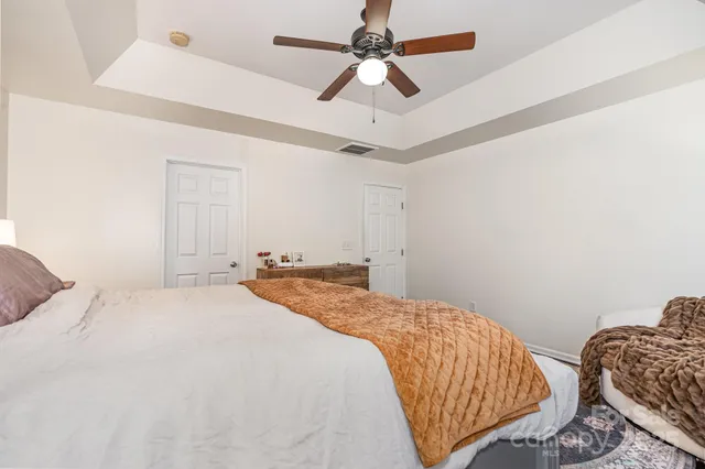 a bedroom with a bed and ceiling fan
