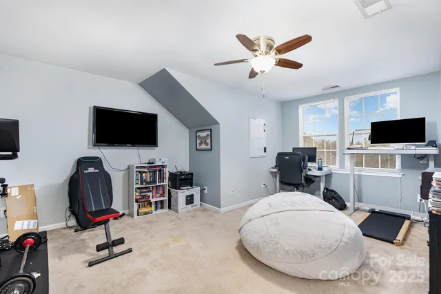 a view of a livingroom with workspace and a window