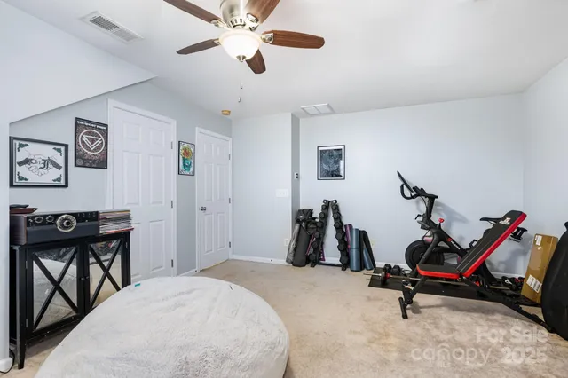 a bedroom with furniture and a gym equipment