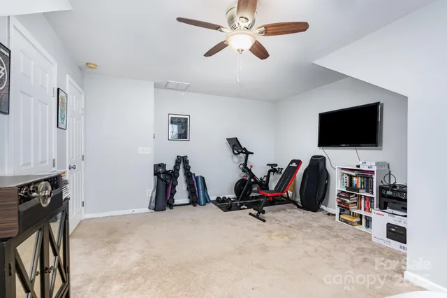 a view of a workspace with furniture and a flat screen tv