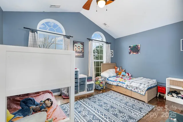 a bedroom with furniture and a chandelier