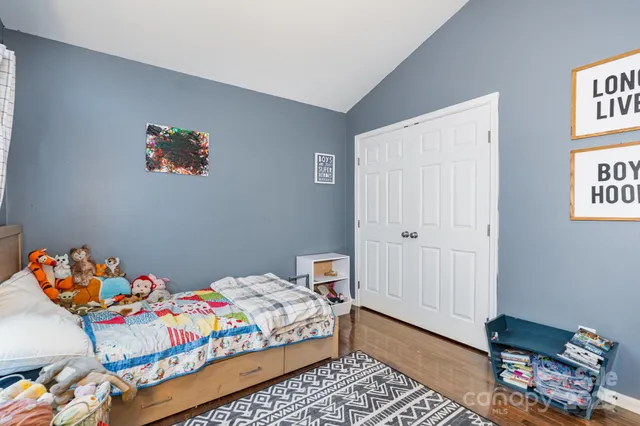 a bedroom with a bed and a dresser in it