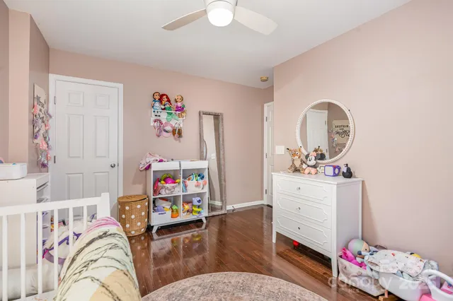 a bedroom with furniture and a wooden floor
