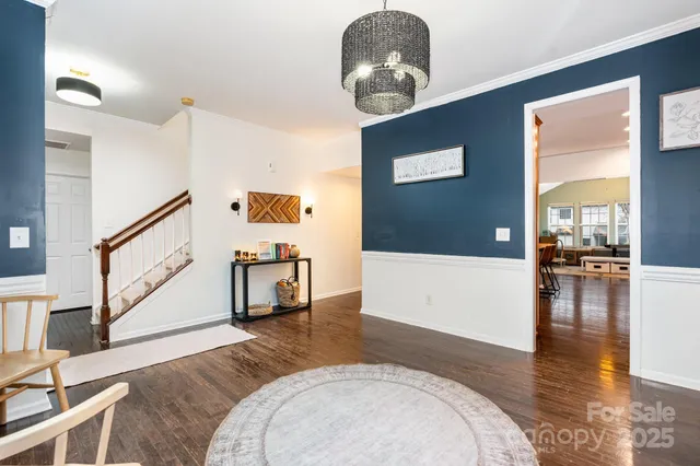 a view of a livingroom with furniture and hardwood floor