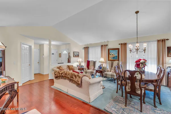 a living room with furniture and a chandelier