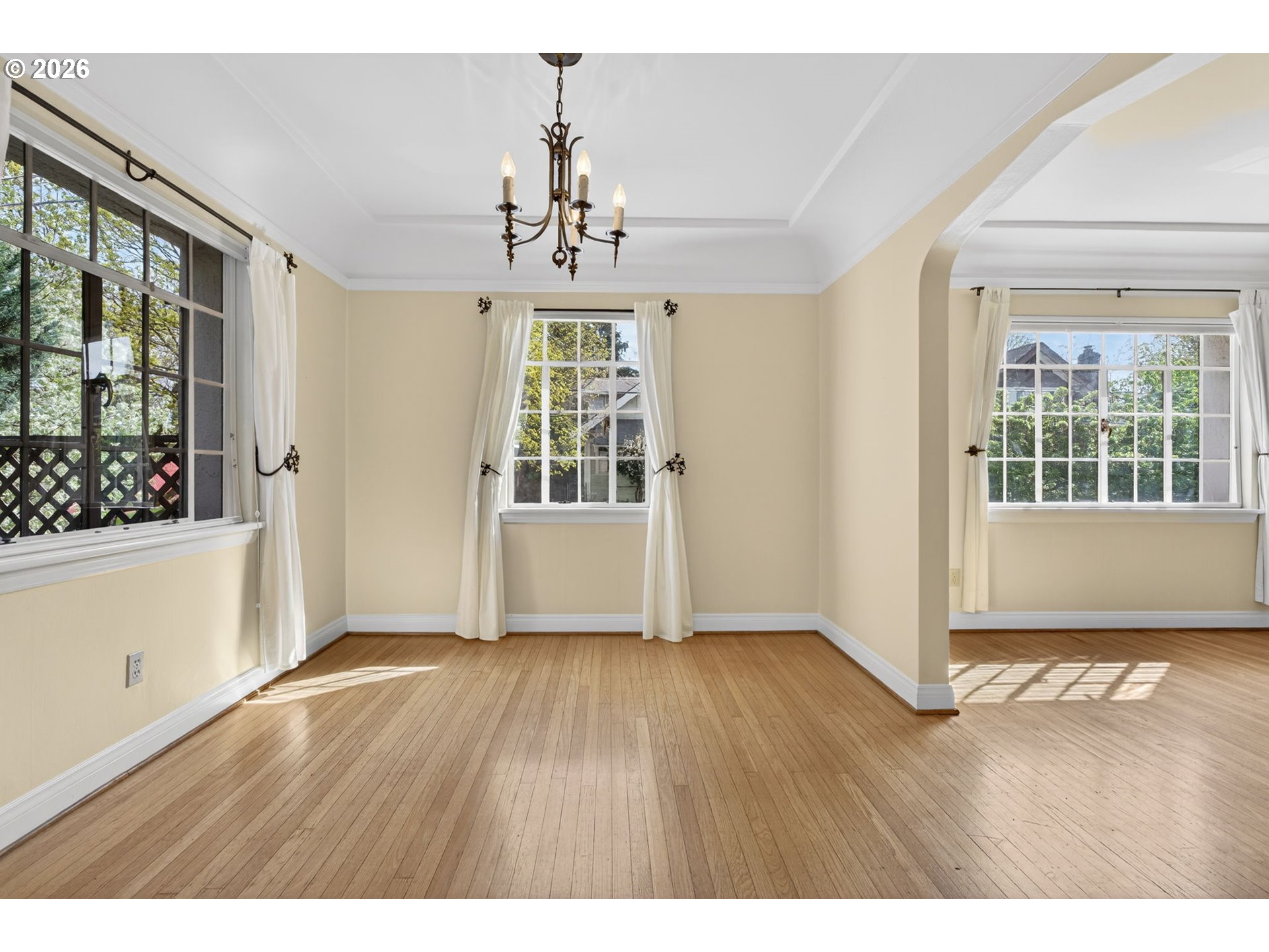 2325 Northeast Flanders Street, Unit 8 Portland, OR 97232 - Photo 11 of 42 a view of an empty room with a window and wooden floor