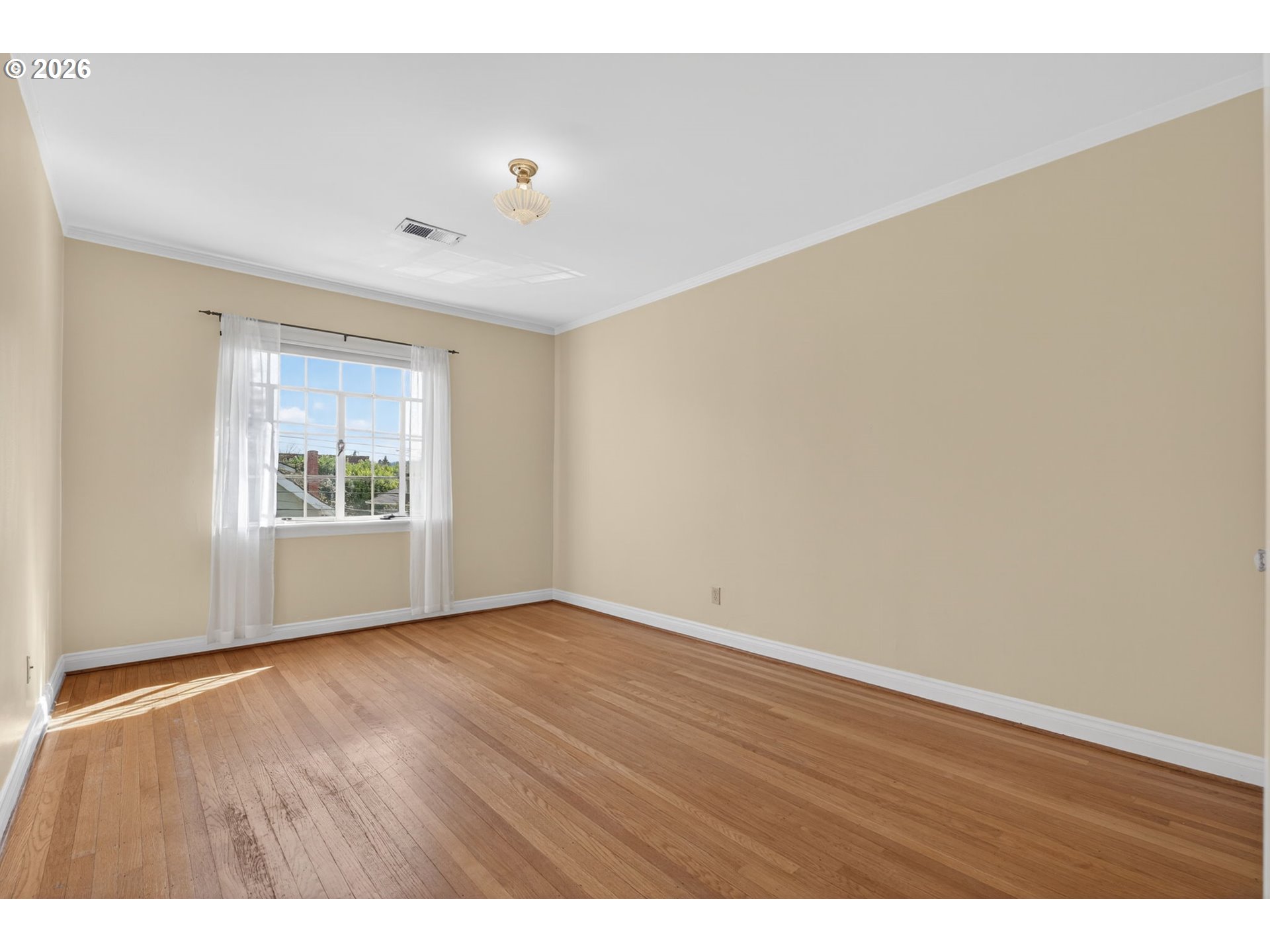 2325 Northeast Flanders Street, Unit 8 Portland, OR 97232 - Photo 18 of 42 a view of an empty room with wooden floor and a window