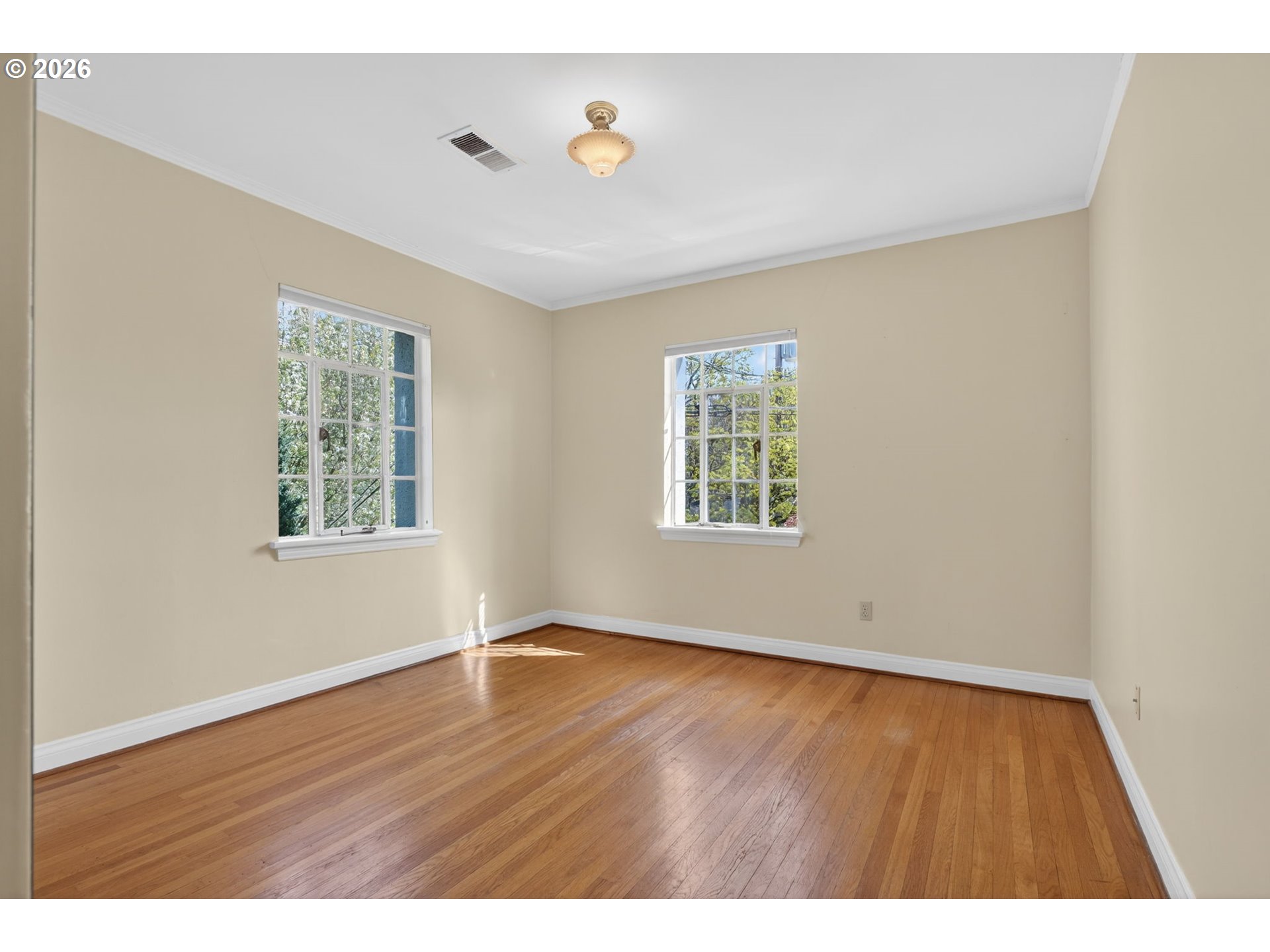 2325 Northeast Flanders Street, Unit 8 Portland, OR 97232 - Photo 24 of 42 a view of an empty room with wooden floor and a window