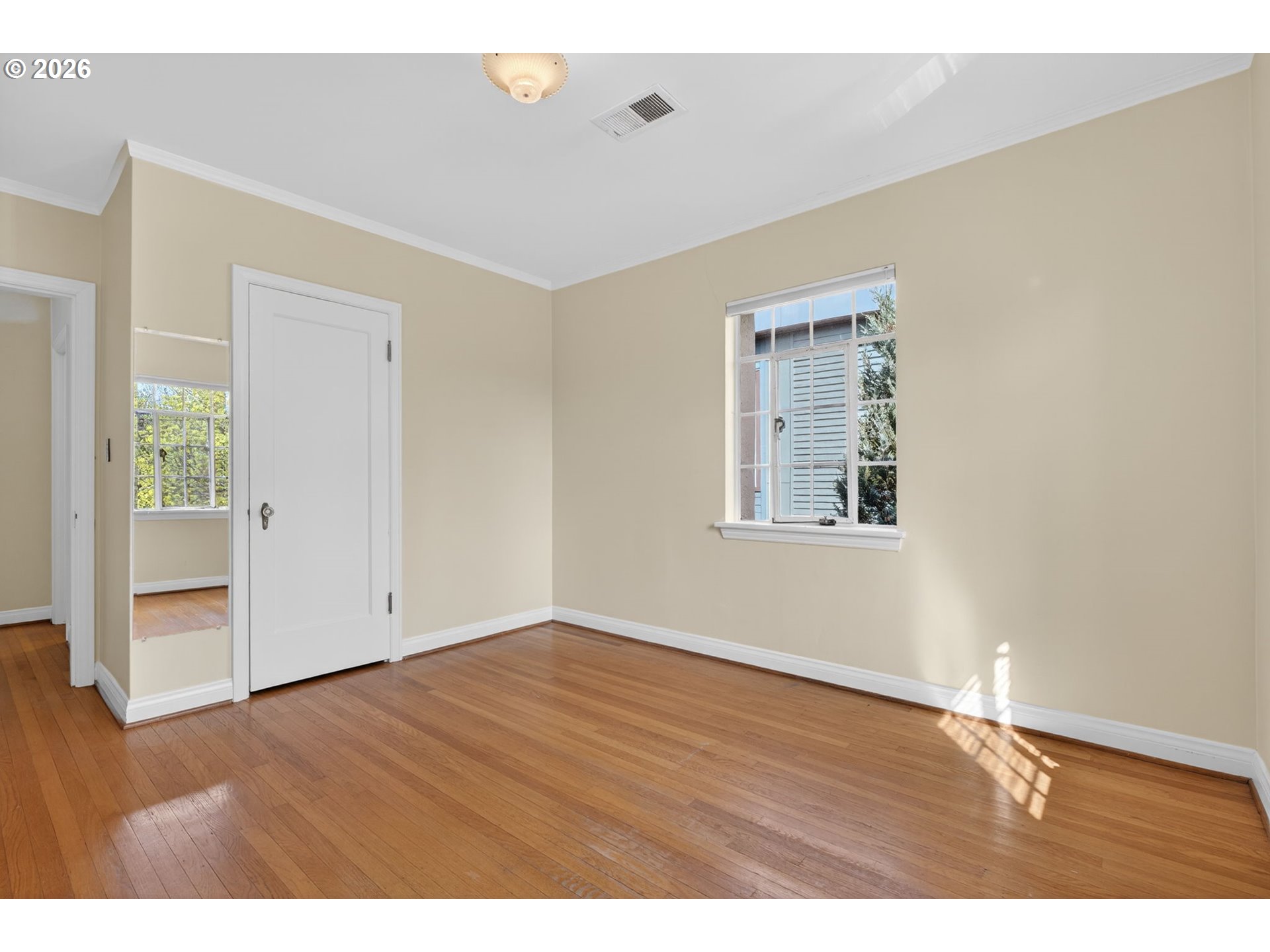 2325 Northeast Flanders Street, Unit 8 Portland, OR 97232 - Photo 25 of 42 a view of an empty room with wooden floor and a window