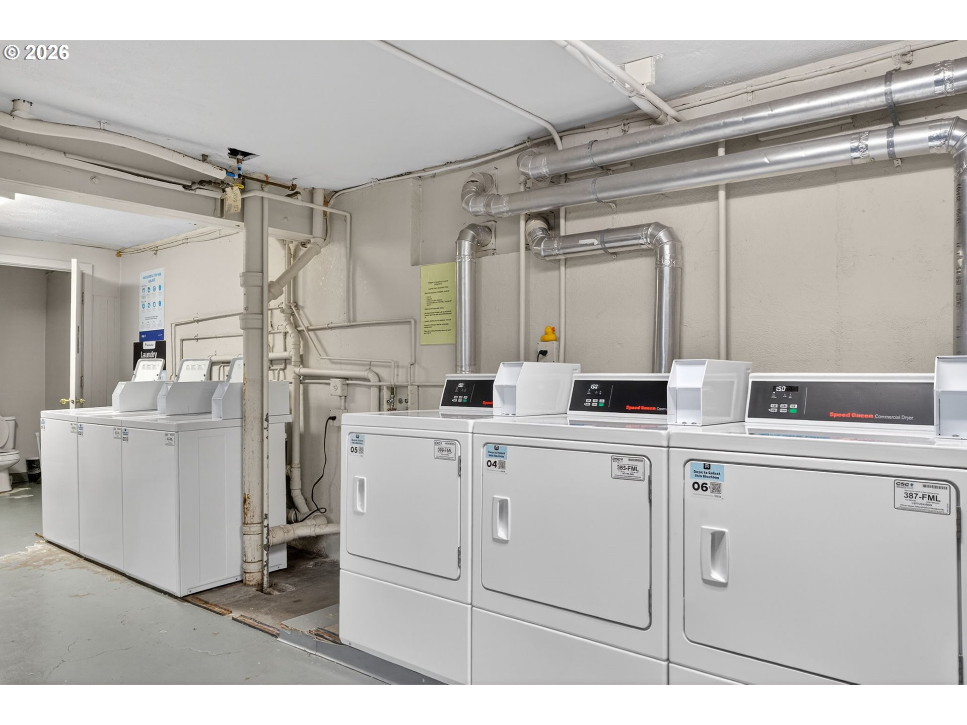 2325 Northeast Flanders Street, Unit 8 Portland, OR 97232 - Photo 31 of 42 a kitchen with white cabinets and white appliances