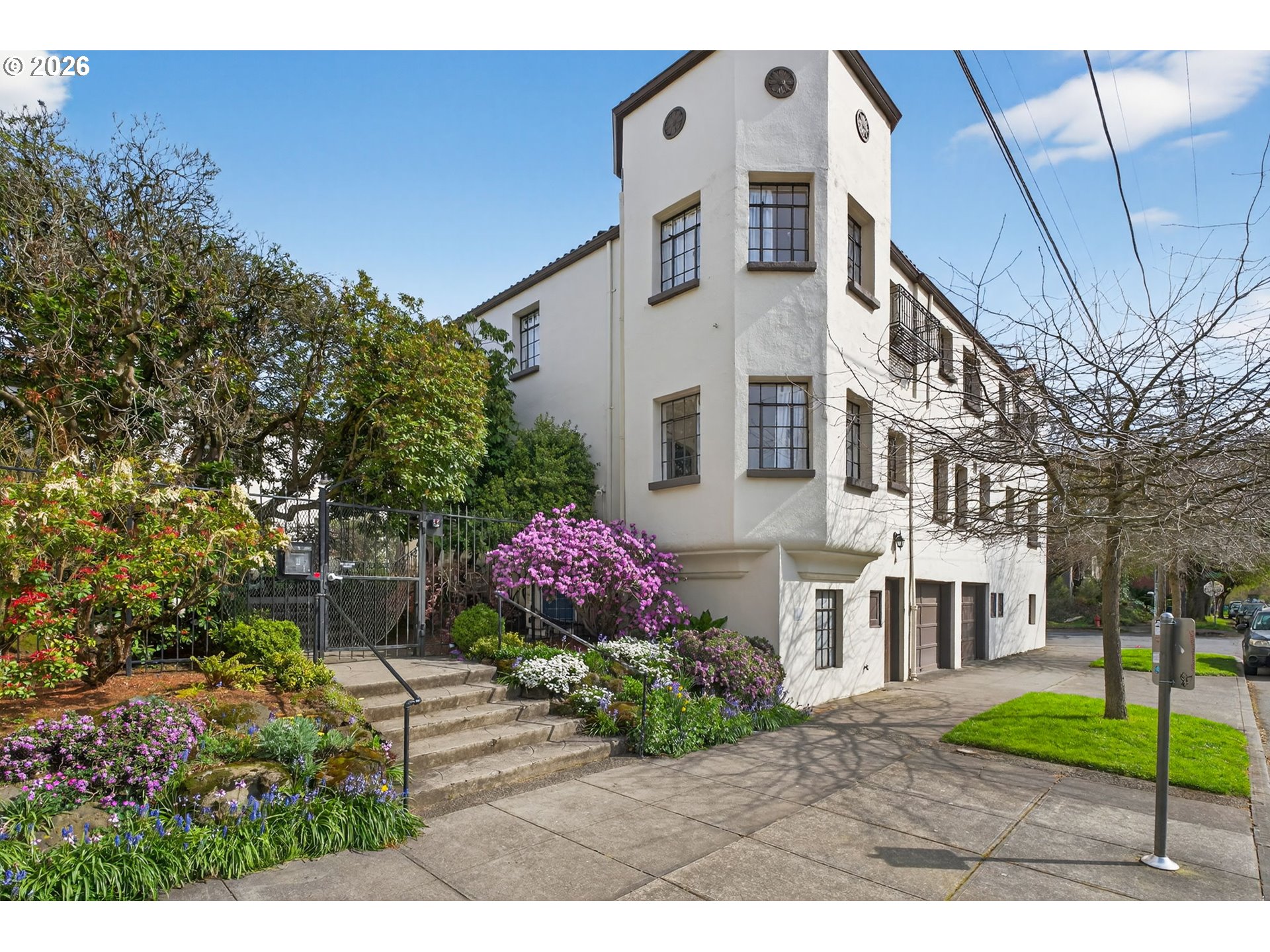 2325 Northeast Flanders Street, Unit 8 Portland, OR 97232 - Photo 40 of 42 a view of a white house with a yard and potted plants