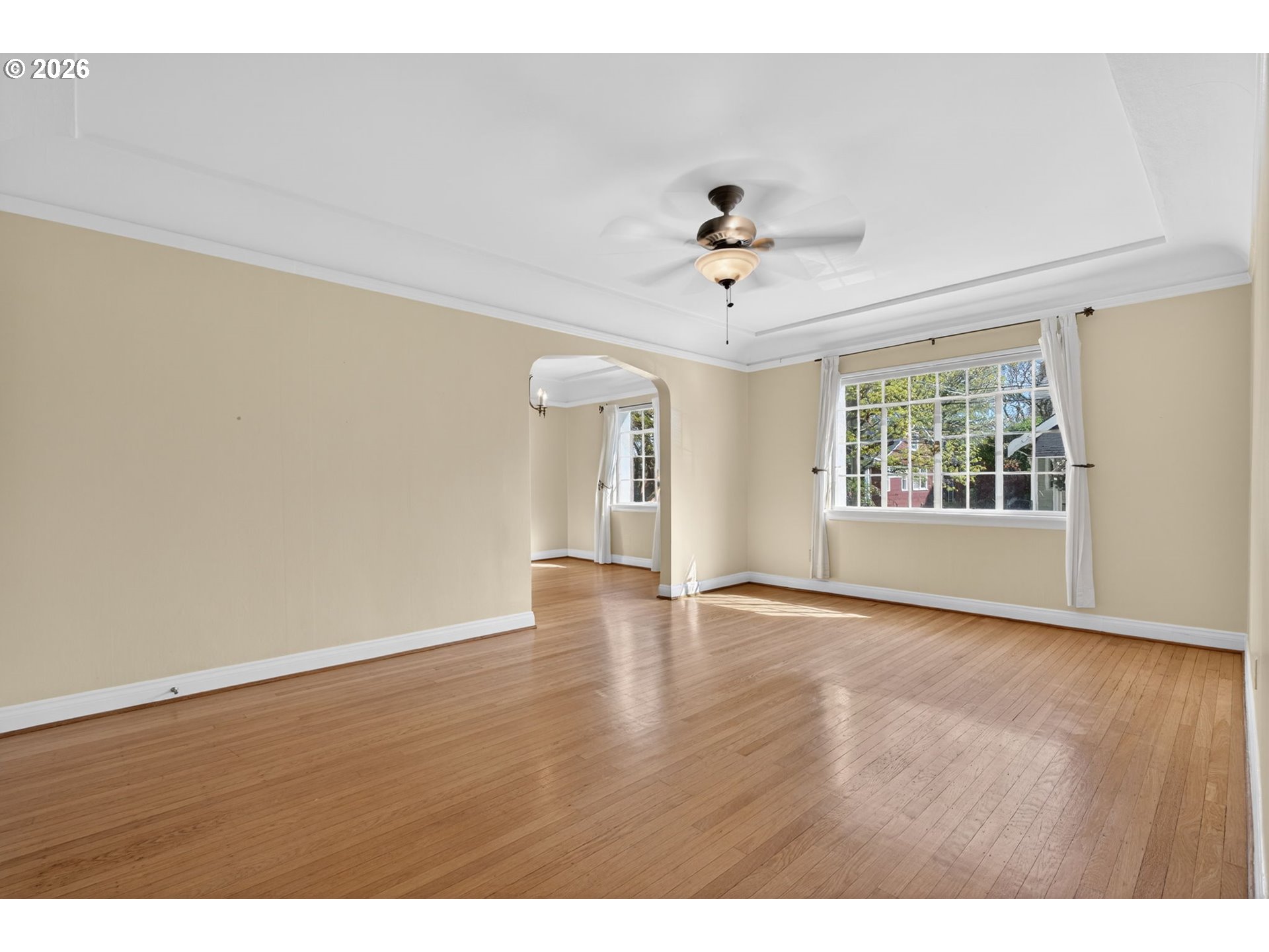 2325 Northeast Flanders Street, Unit 8 Portland, OR 97232 - Photo 6 of 42 a view of an empty room with a window and wooden floor