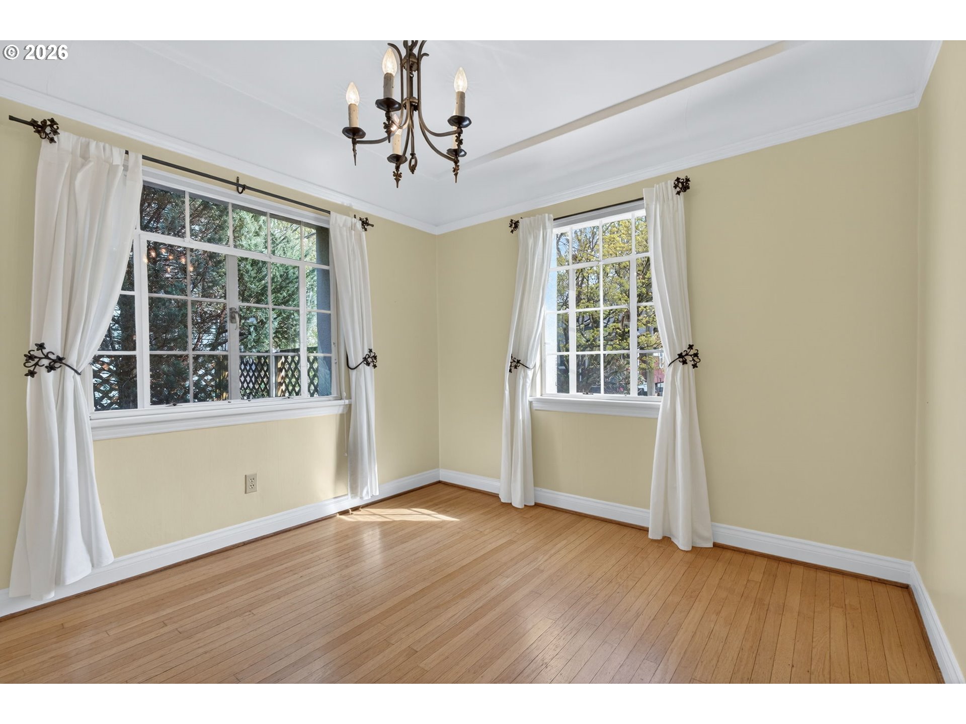 2325 Northeast Flanders Street, Unit 8 Portland, OR 97232 - Photo 10 of 42 a view of an empty room with wooden floor and a window