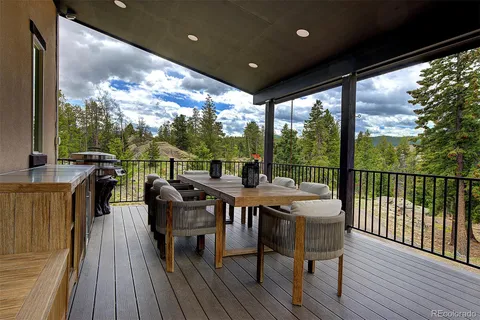 a view of a balcony with chairs and wooden floor