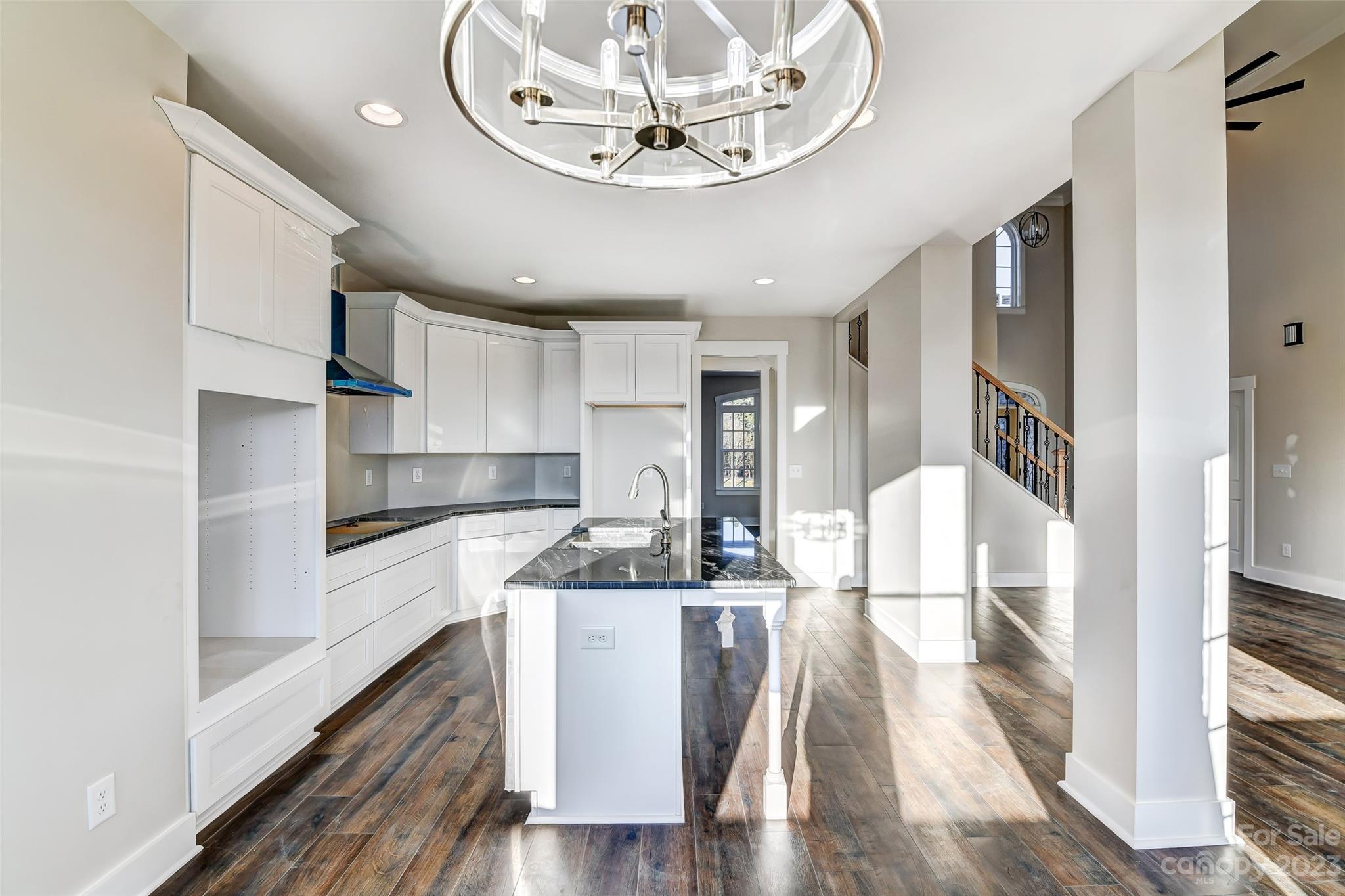 4308 White Tail Lane Midland, NC 28107 - Photo 12 of 37 a kitchen with kitchen island stainless steel appliances a dining table chairs and granite counter tops