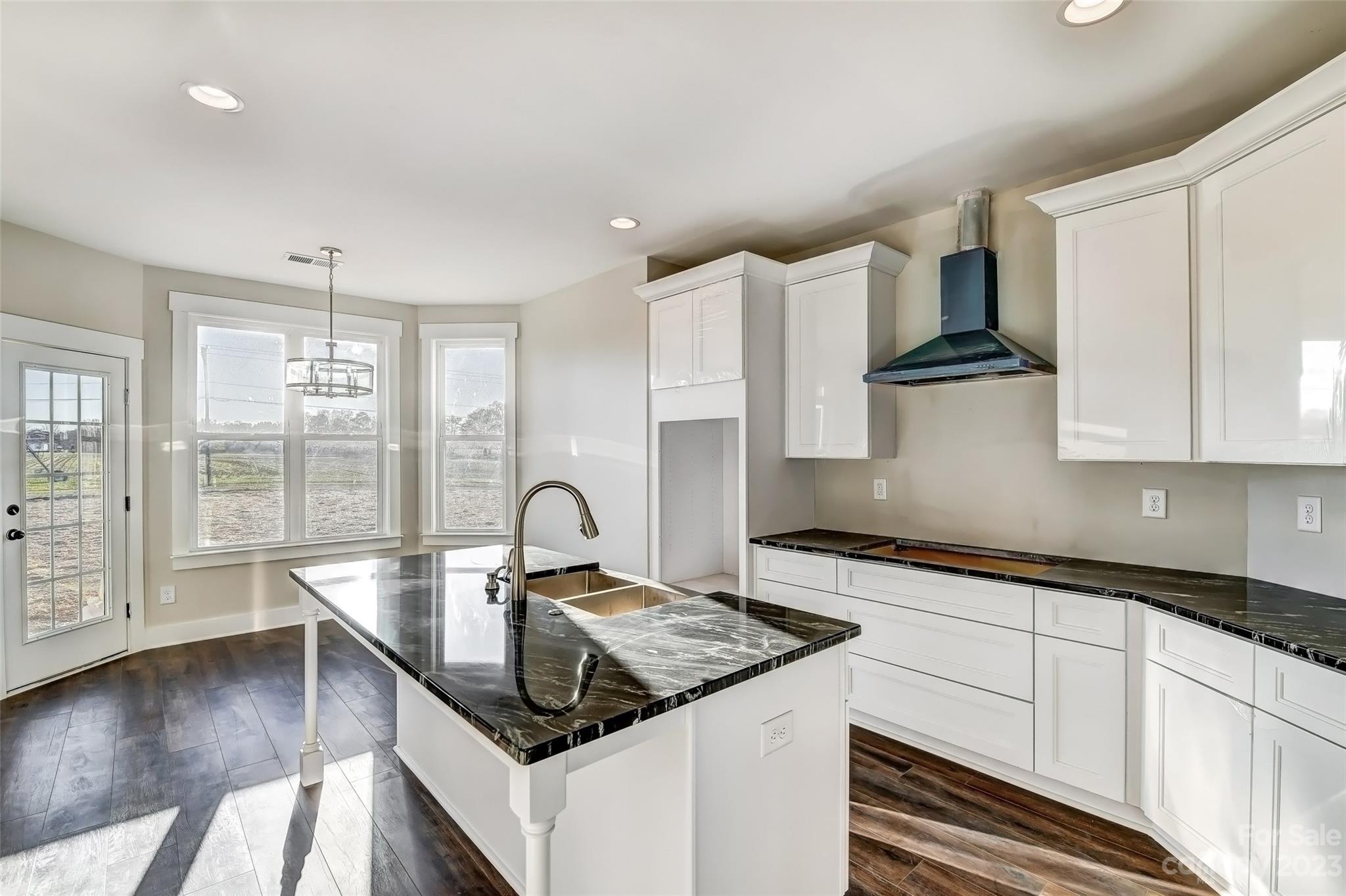 4308 White Tail Lane Midland, NC 28107 - Photo 13 of 37 a kitchen with granite countertop a sink stove and cabinets