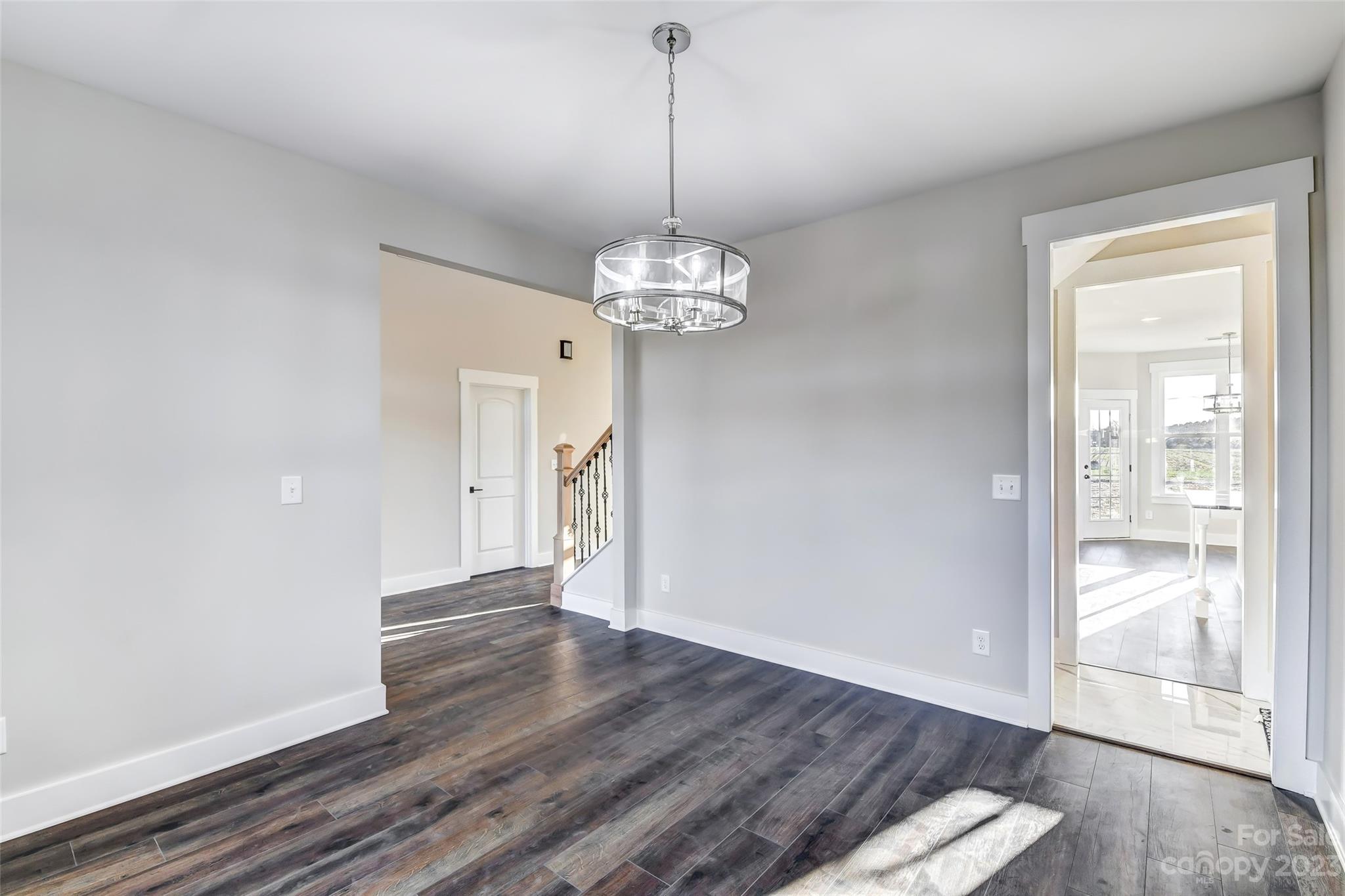4308 White Tail Lane Midland, NC 28107 - Photo 18 of 37 a view of a hallway with wooden floor and a chandelier