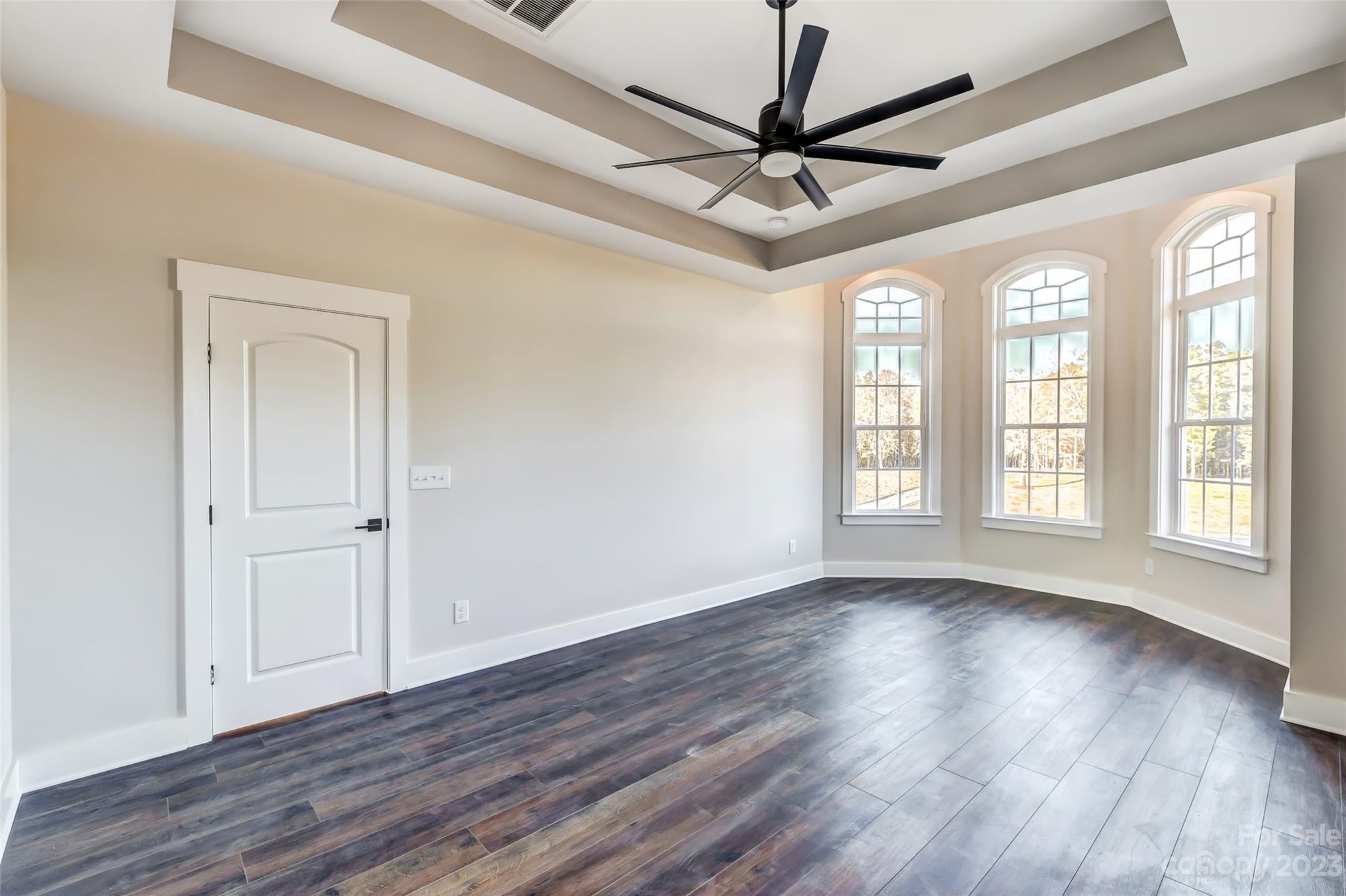 4308 White Tail Lane Midland, NC 28107 - Photo 22 of 37 a view of an empty room with wooden floor and a window