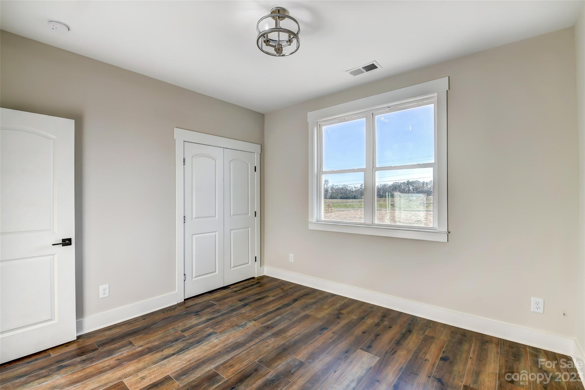 4308 White Tail Lane Midland, NC 28107 - Photo 28 of 37 a view of an empty room with wooden floor and a window