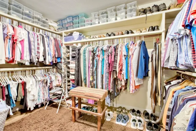a view of a dining room with furniture a potted plant and wooden floor