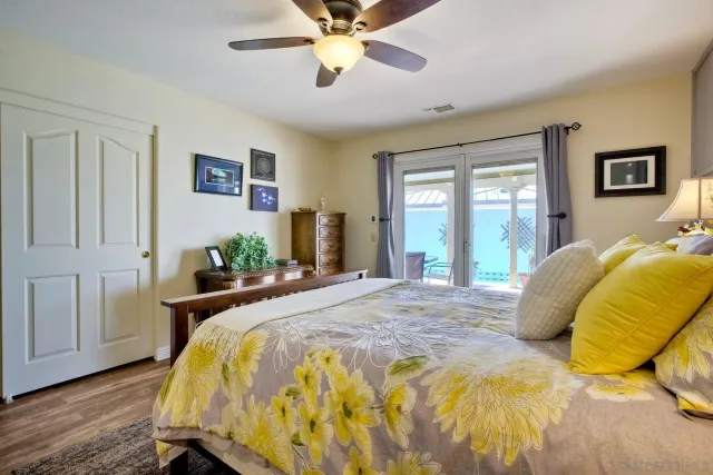 a bathroom with a granite countertop toilet sink and mirror