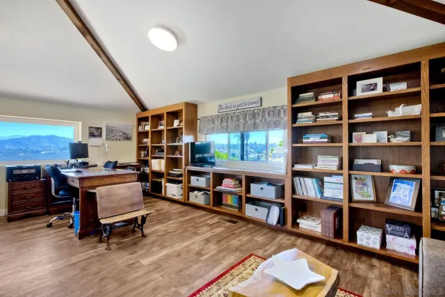 a view of a patio with dining table and chairs with a small yard