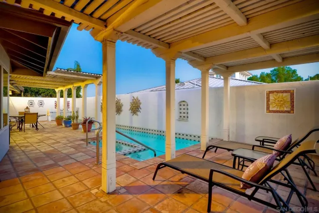 a green field with lots of trees in the background