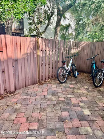 a view of a backyard with wooden fence