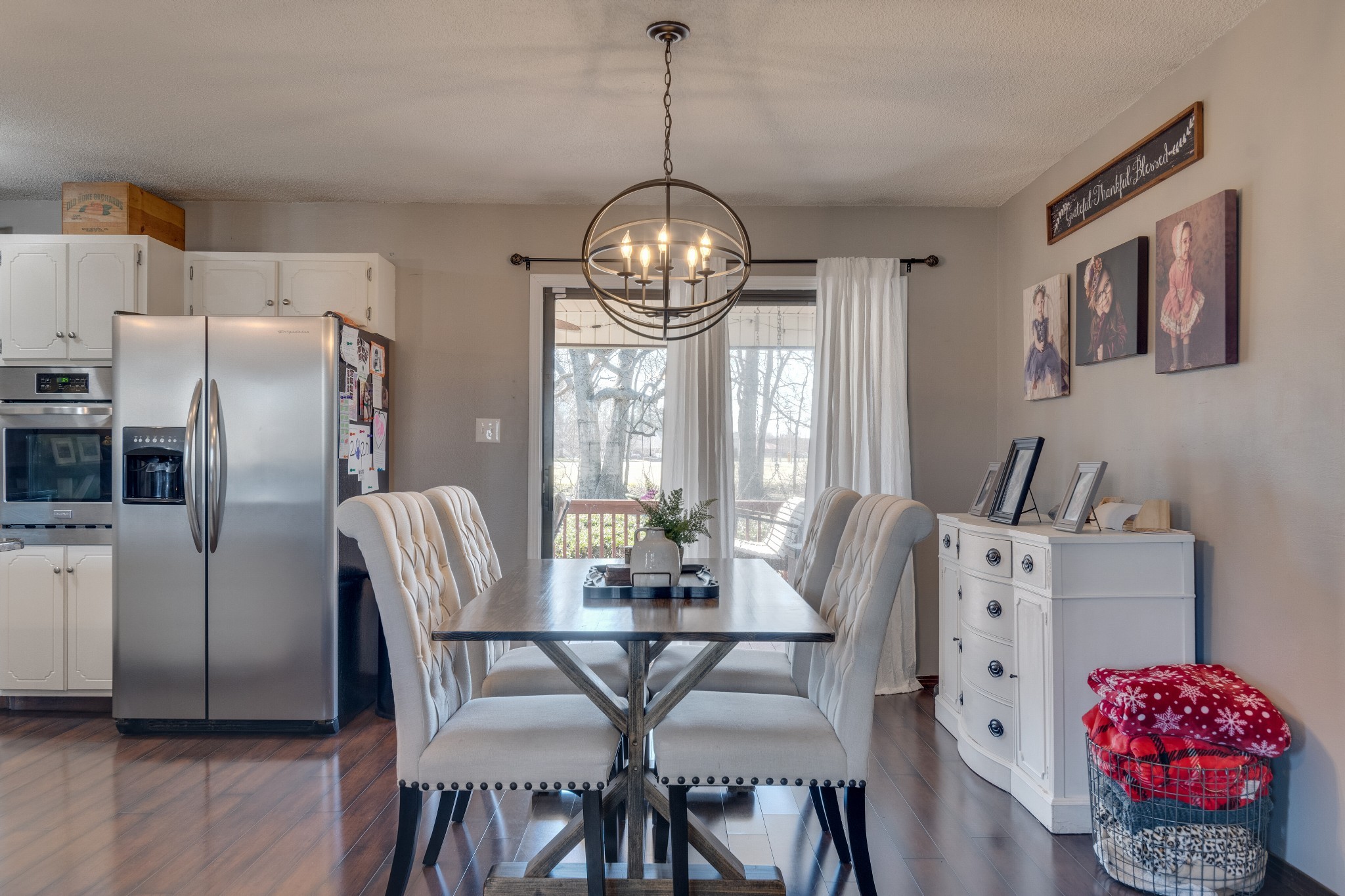 403 Mockingbird Drive Mount Pleasant, TN 38474 - Photo 13 of 26 a view of a dining room with furniture a chandelier and wooden floor