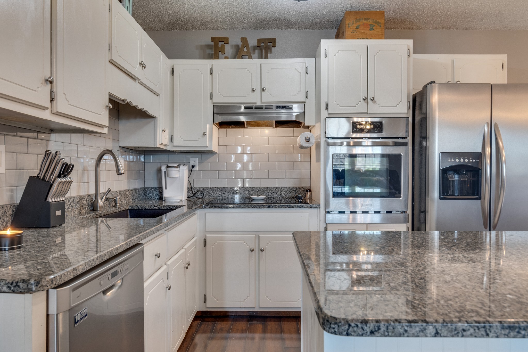 403 Mockingbird Drive Mount Pleasant, TN 38474 - Photo 14 of 26 a kitchen with stainless steel appliances granite countertop a refrigerator a sink and white cabinets