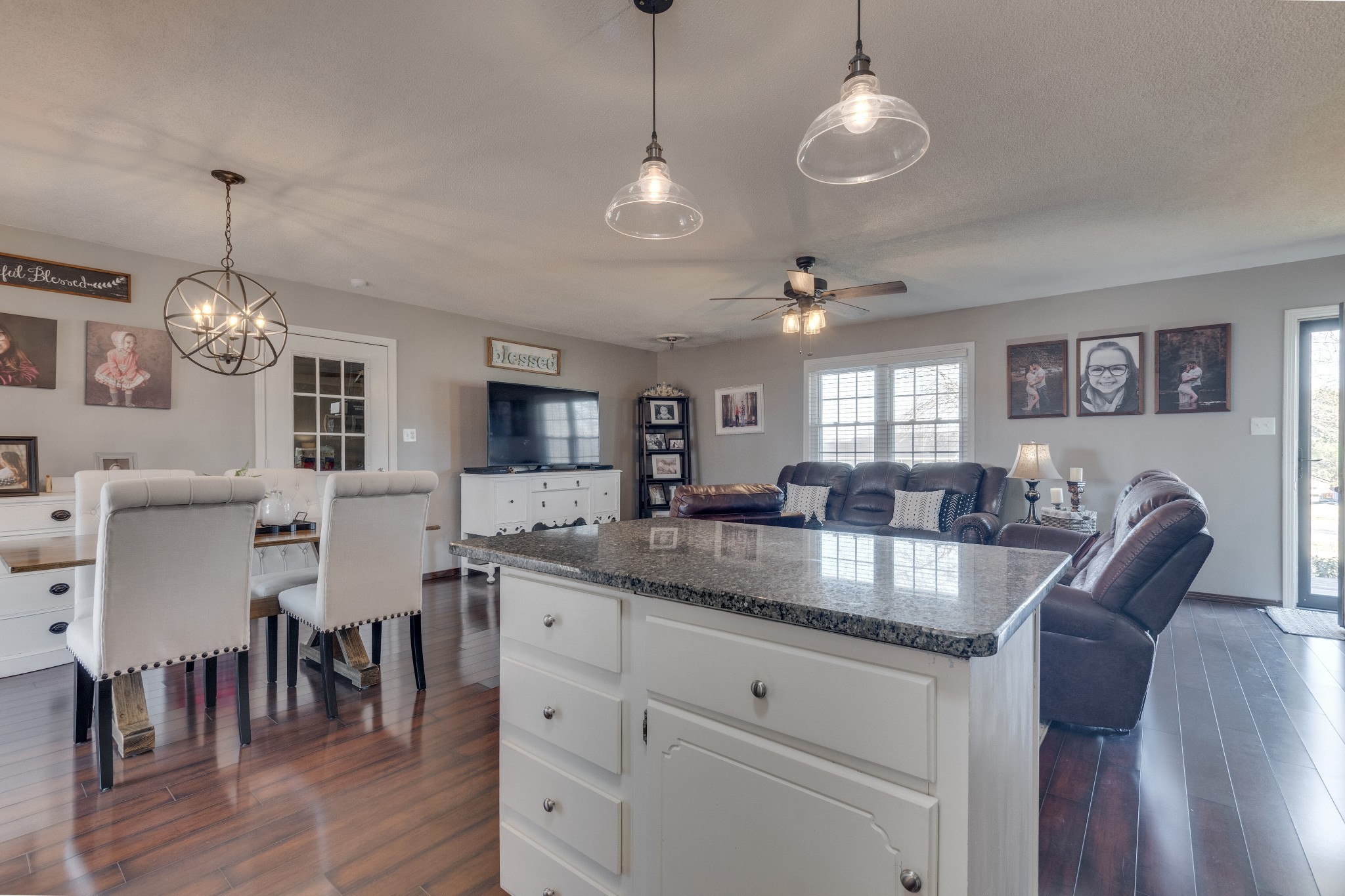 403 Mockingbird Drive Mount Pleasant, TN 38474 - Photo 15 of 26 a kitchen with center island a sink dishwasher a dining table and chairs with wooden floor