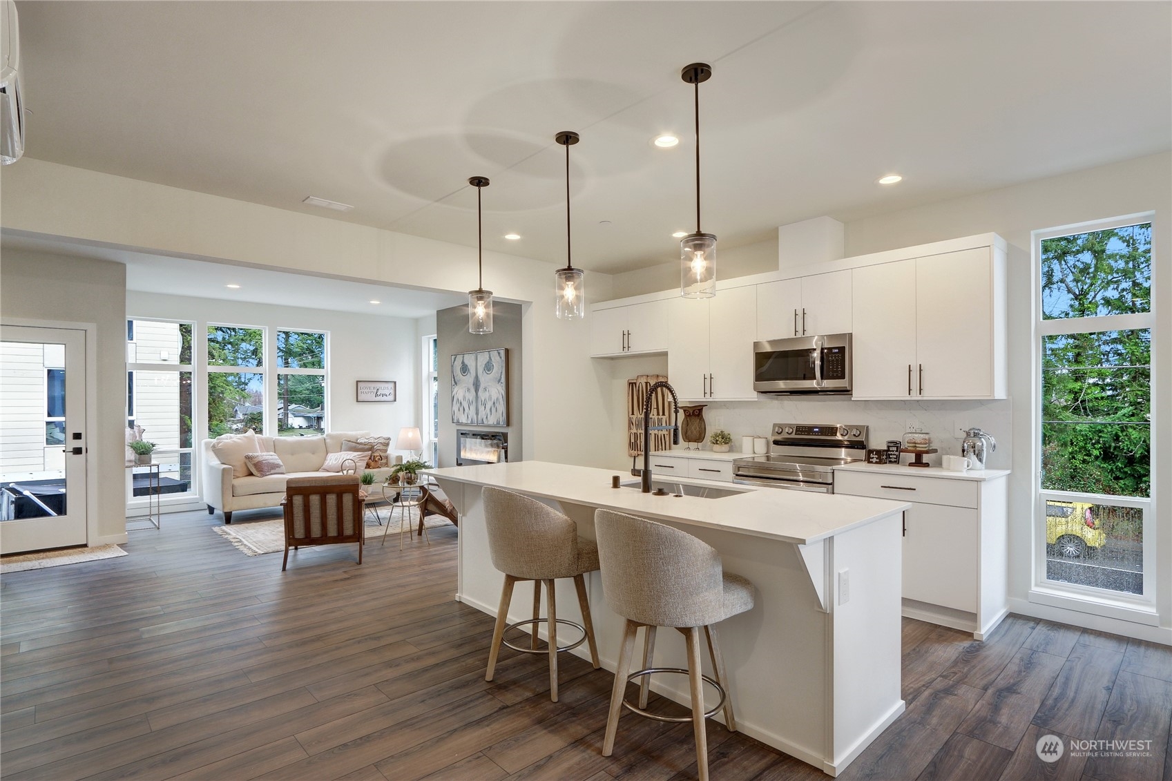 2527 Gibson Road, Unit A5 Everett, WA 98204 - Photo 5 of 21 a kitchen with stainless steel appliances a dining table chairs stove a refrigerator and cabinets