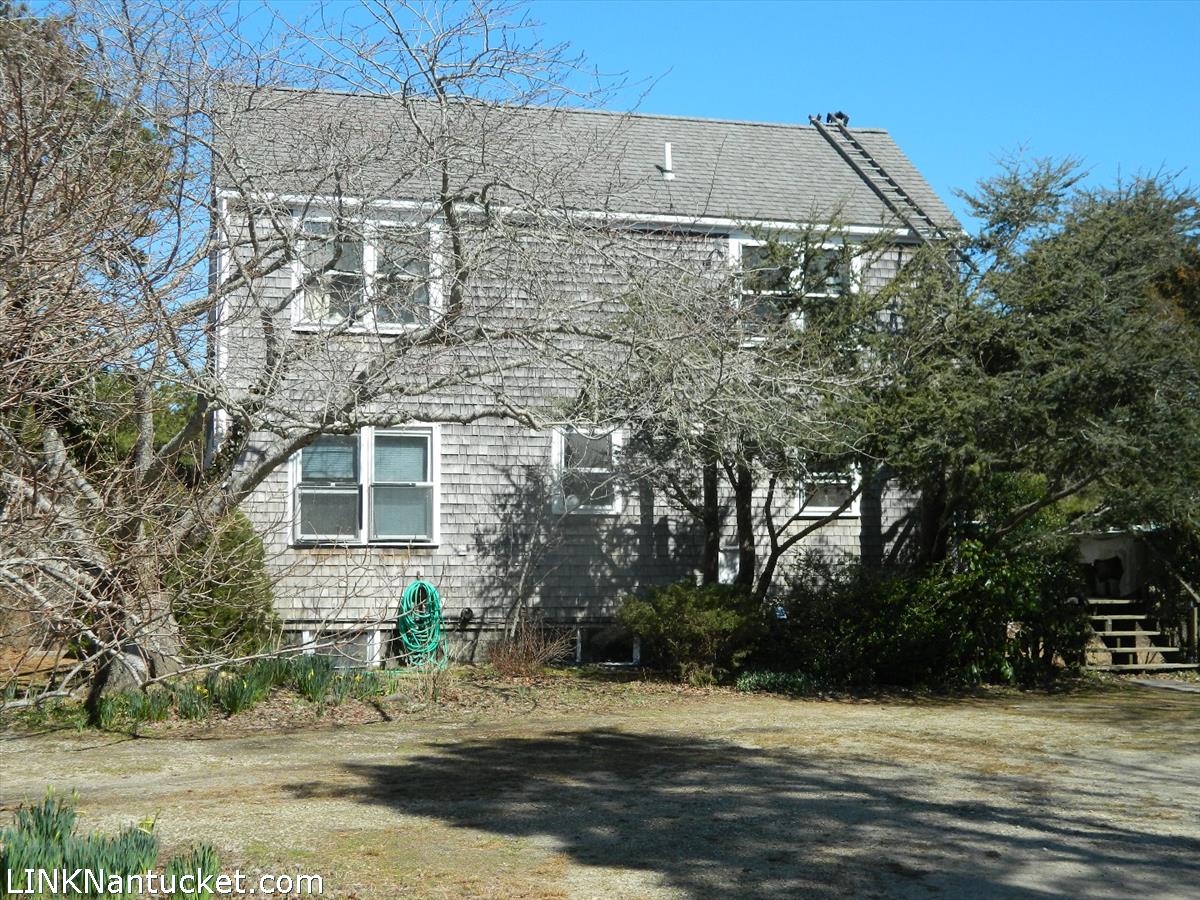 34 Hinsdale Road Nantucket, MA 02554 - Photo 1 of 7 a view of a brick house with a yard