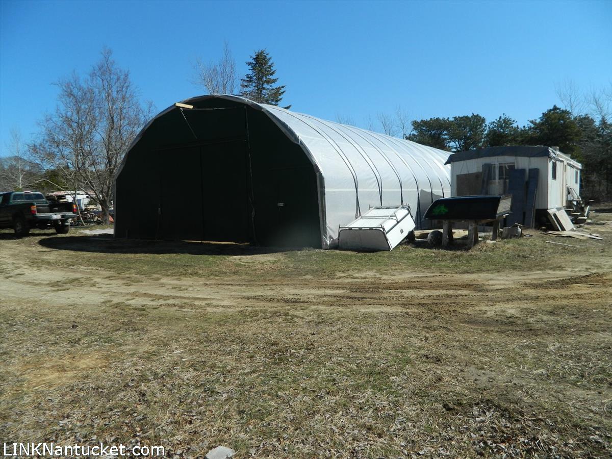 34 Hinsdale Road Nantucket, MA 02554 - Photo 2 of 7 a black car is parked in front of a house