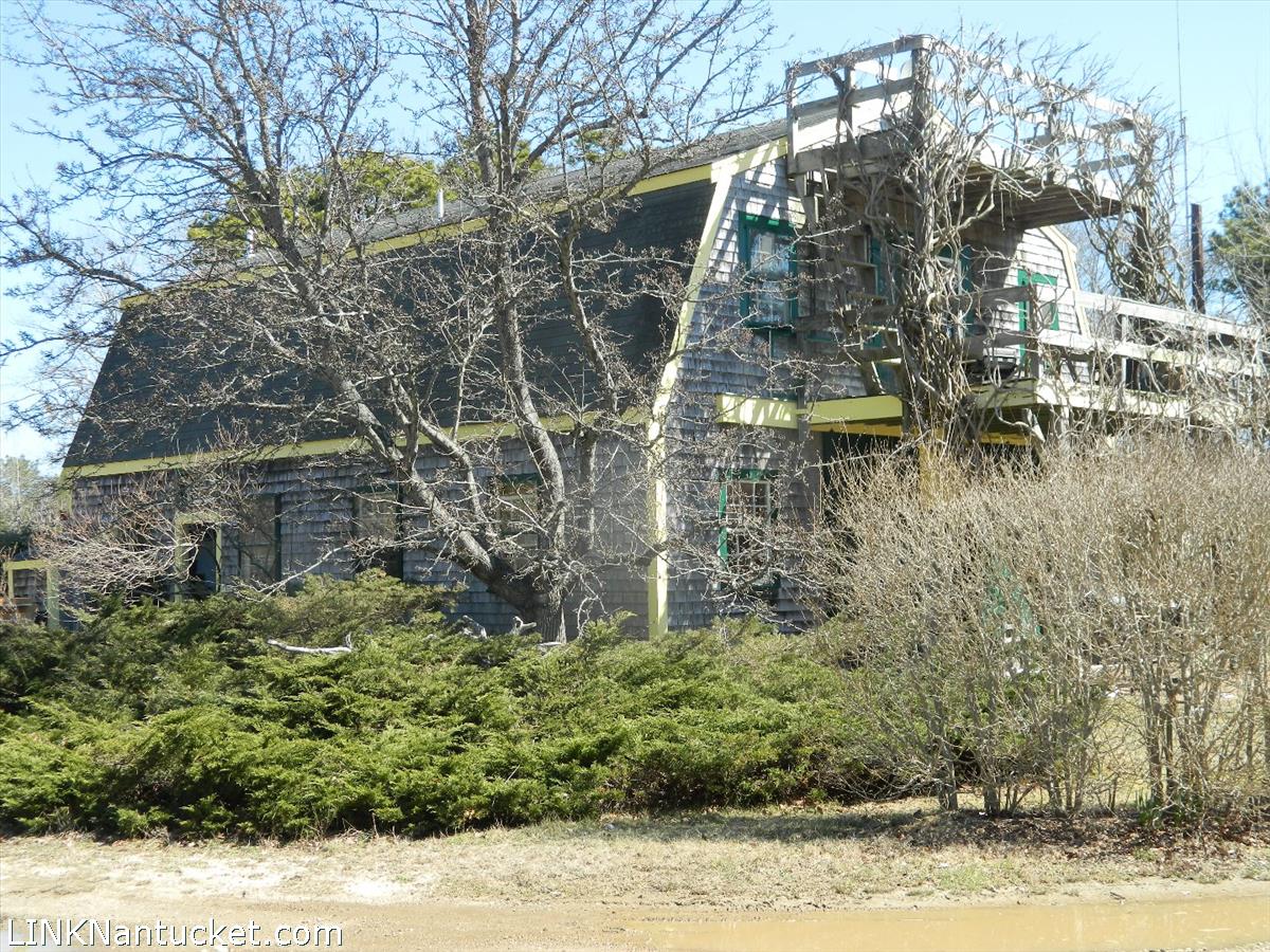 34 Hinsdale Road Nantucket, MA 02554 - Photo 5 of 7 a backyard of a building with large trees