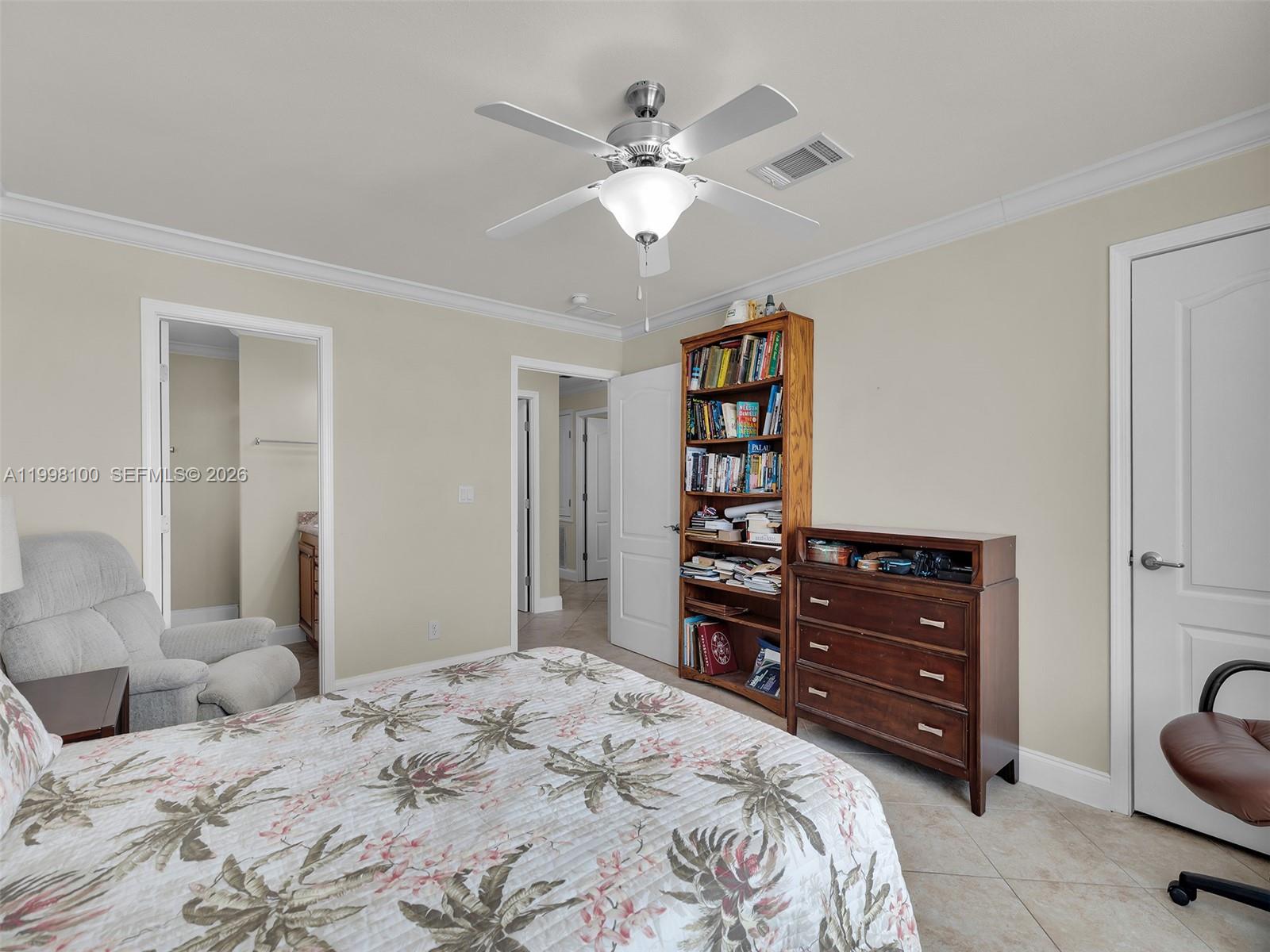 437 Pirates Road Summerland Key, FL 33042 - Photo 26 of 39 a bedroom with a bed window and a chandelier