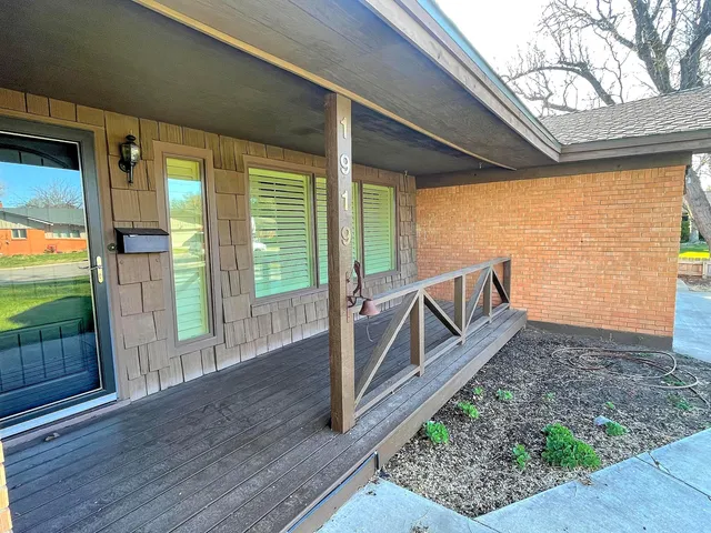 a view of balcony with floor to ceiling window and wooden floor