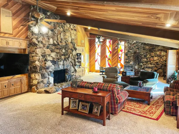 a living room with furniture a flat screen tv and a fireplace