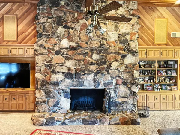 a living room with a fireplace and a flat screen tv