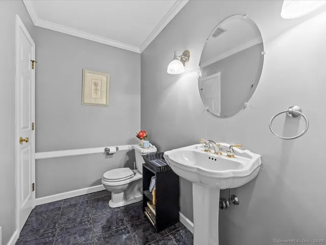 a bathroom with a sink toilet and a mirror