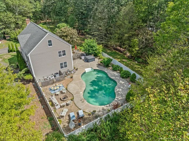 an aerial view of a house with a yard and plants