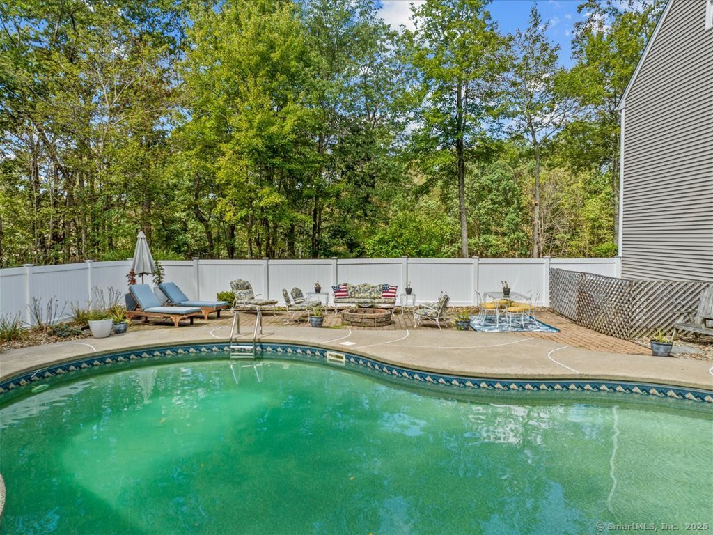 30 Renees Way Madison, CT 06443 - Photo 25 of 40 a swimming pool with outdoor seating and yard