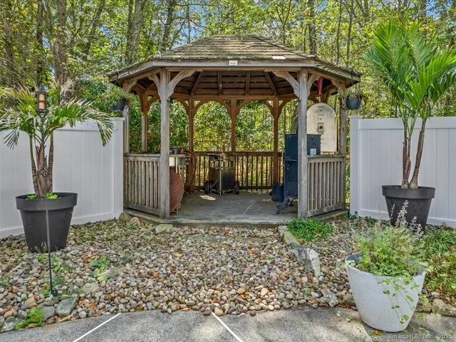 a view of a deck with table and chairs under an umbrella