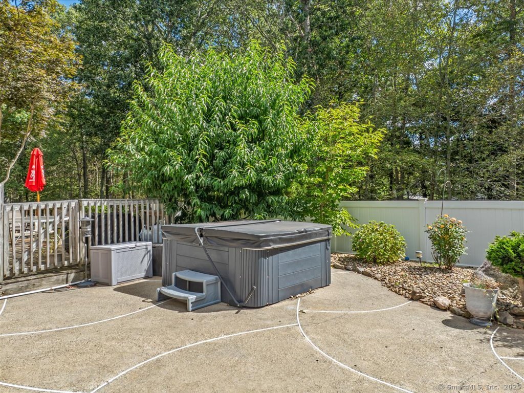 30 Renees Way Madison, CT 06443 - Photo 27 of 40 a backyard of a house with fountain and outdoor seating