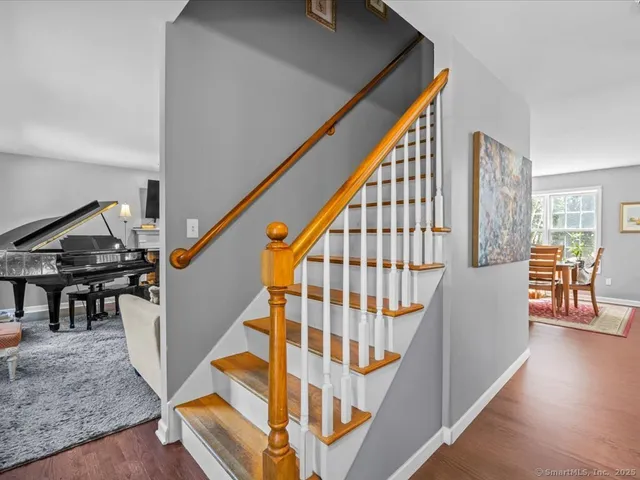 a view of entryway and hall with wooden floor