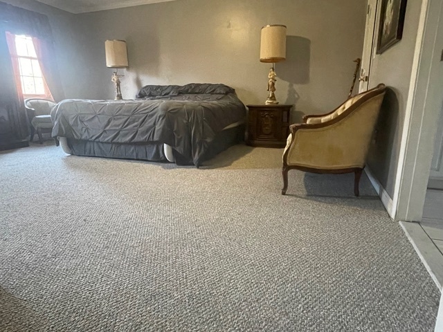 30 Renees Way Madison, CT 06443 - Photo 31 of 40 a bedroom with a bed and lamp