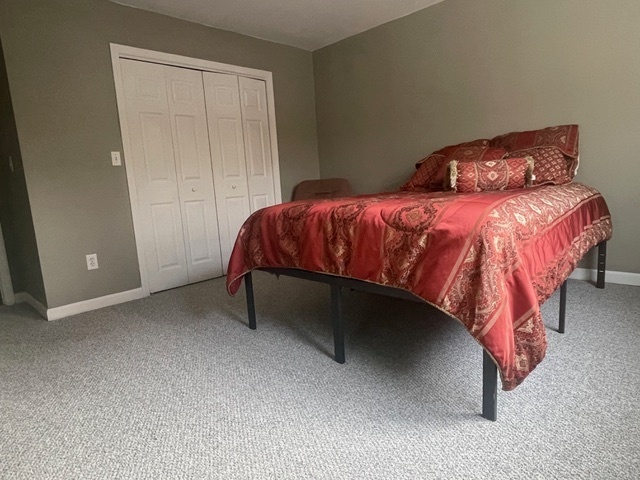 30 Renees Way Madison, CT 06443 - Photo 34 of 40 a bedroom with a bed and a table