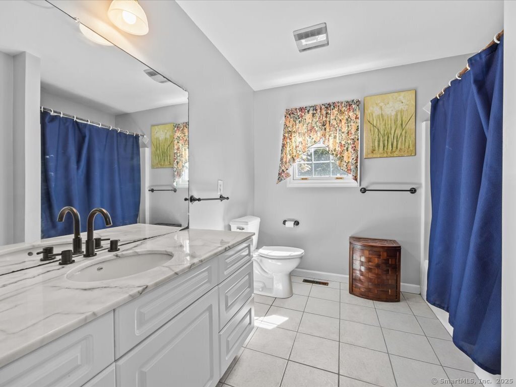 30 Renees Way Madison, CT 06443 - Photo 36 of 40 a bathroom with a sink a toilet and mirror